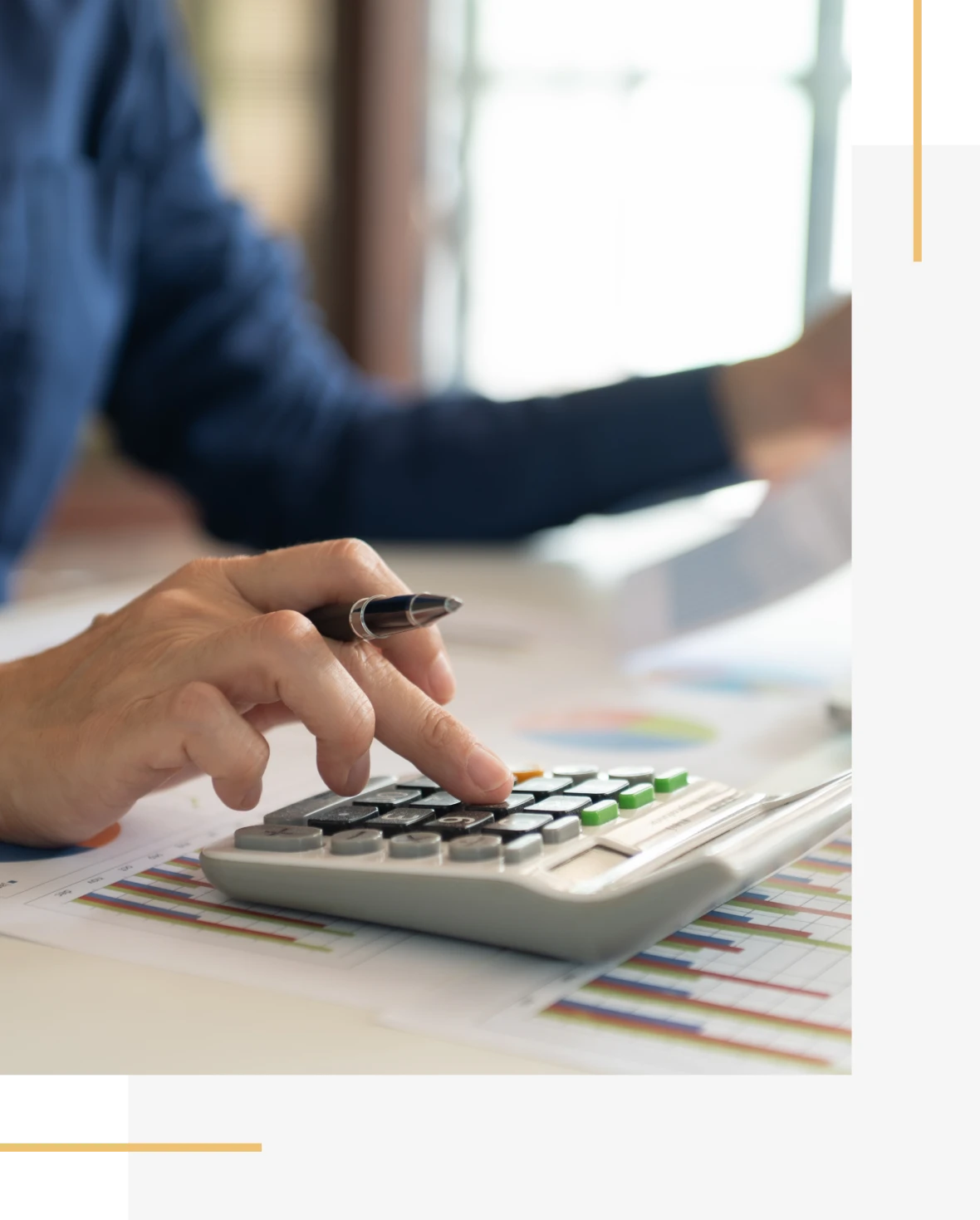 Person calculates expenses with a pen