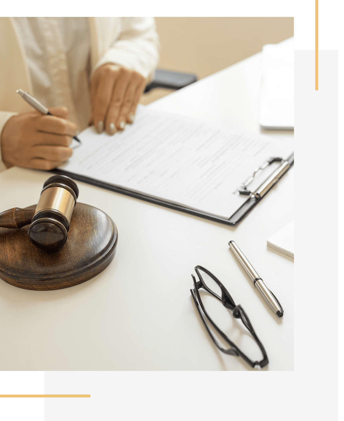 Lawyer reviewing documents with gavel nearby